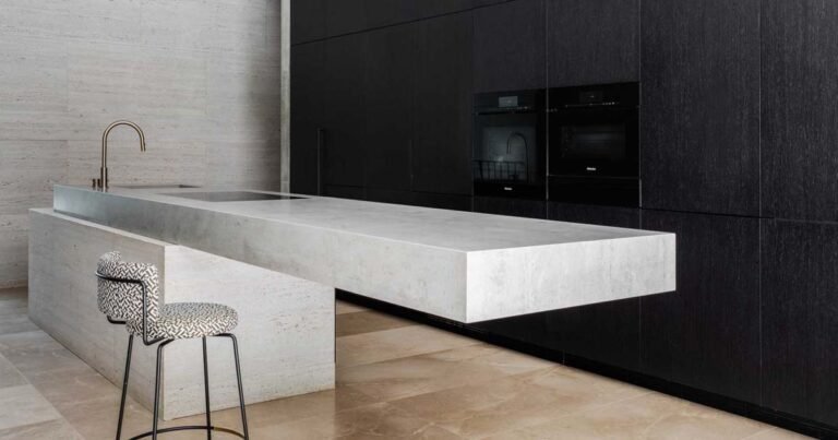 A Cantilevered Island Is A Dramatic Feature In This Minimalist Kitchen