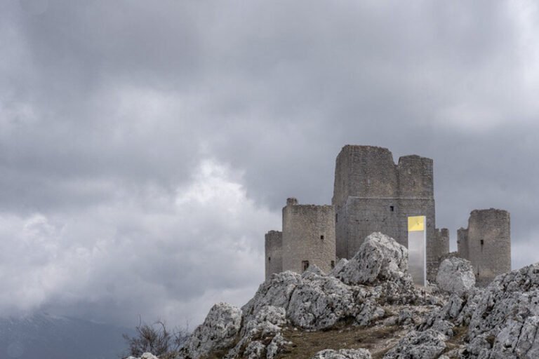 kinetic mirror totem by edoardo dionea cicconi distorts medieval fort surroundings in italy