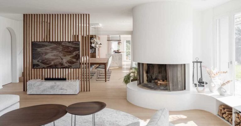 A Round Fireplace Is A Unique Feature In The Living Room Of This Remodeled Home