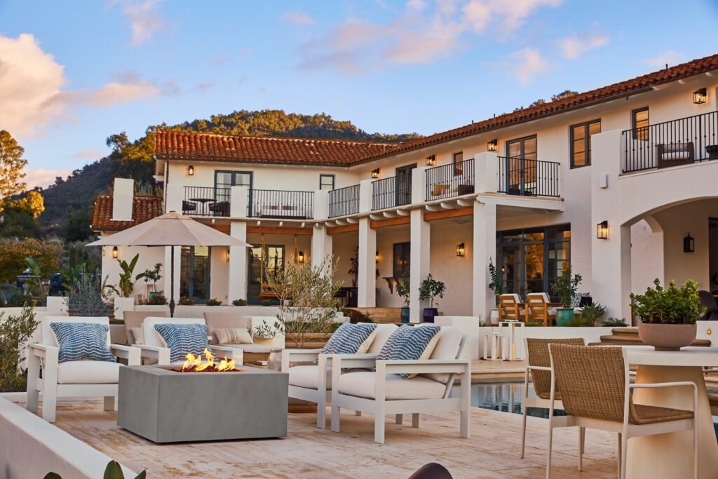 حفرة نار من Pottery Barn محاطة بكراسي صالة Malibu المعدنية ذات العلامات التجارية المغطاة بوسائد الأثاث والأزرق ...