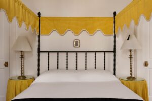 غرفة نوم صفراء مشمسة مجهزة بقماش شوماخر