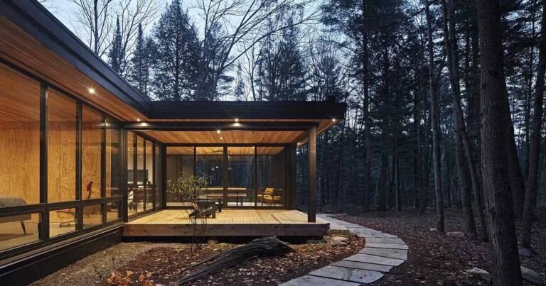 A Modern L-Shaped Home Surrounded By A Pine Tree Forest