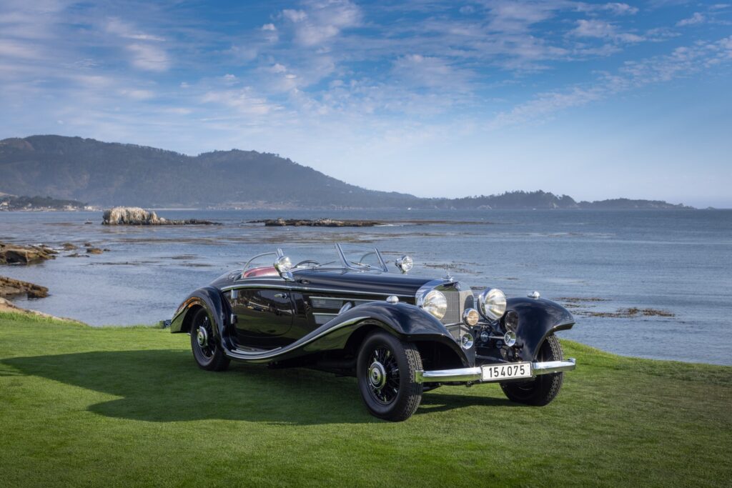 car on grass by ocean