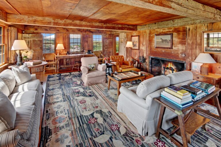 living area with white sofas wood beam ceilings fireplace