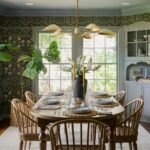 The coziness of the dining room owes a lot to the inviting botanical wallpaper which is a vinyl peelandstick option from...