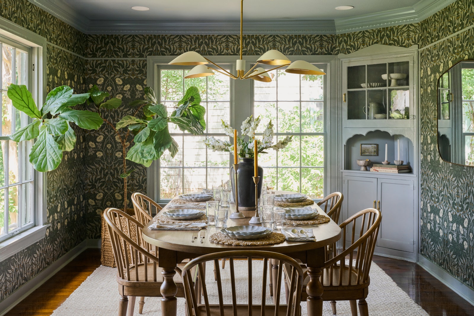 The coziness of the dining room owes a lot to the inviting botanical wallpaper which is a vinyl peelandstick option from...