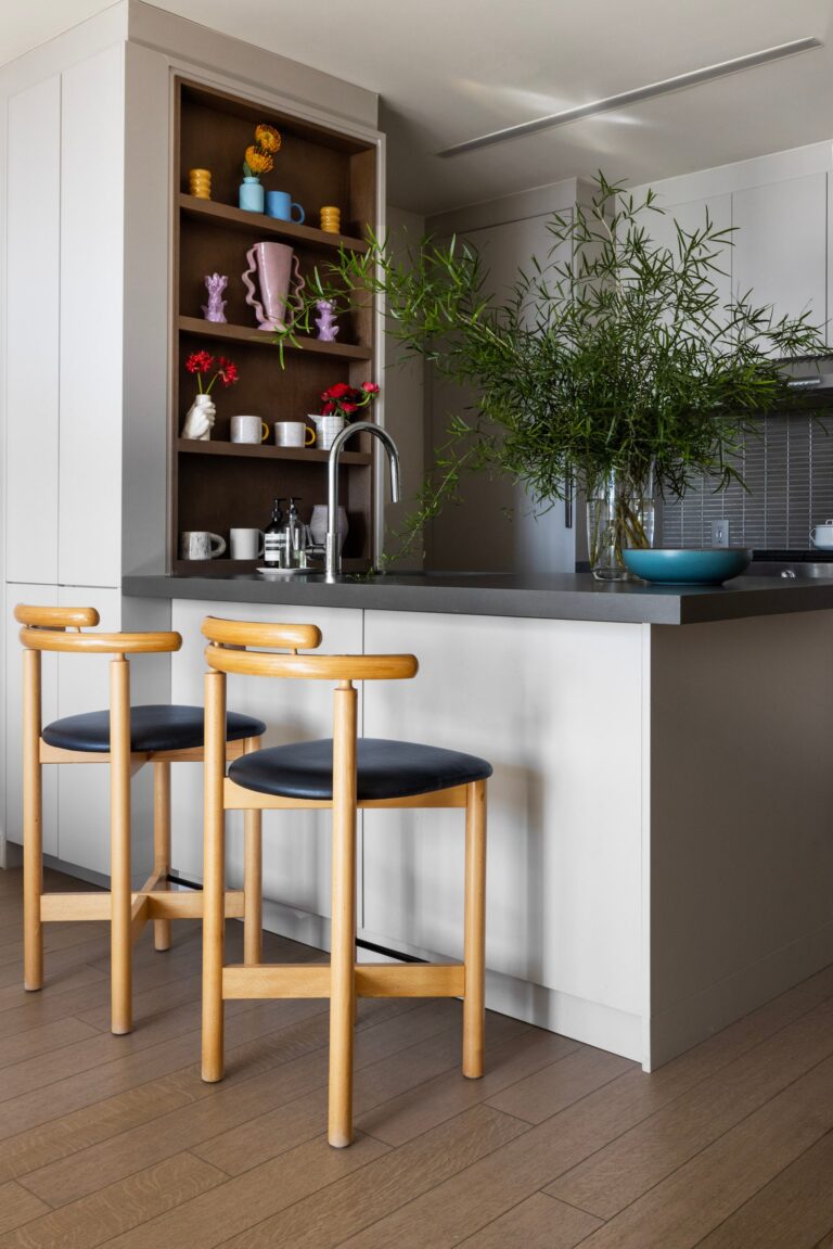 Colorful vessels brighten up the gray and white kitchen.