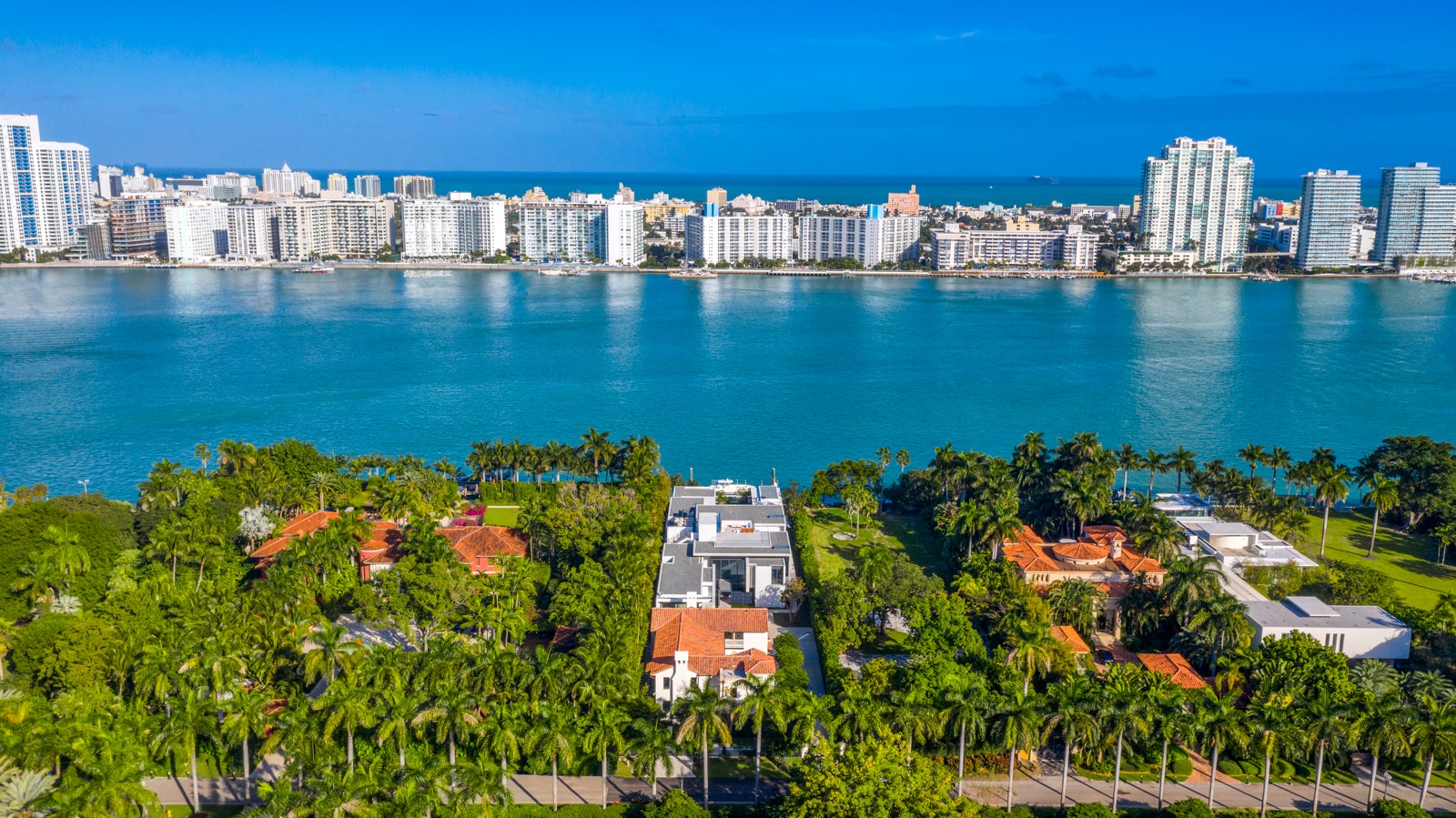 aerial shot of a plot of land with two homes on it on an island