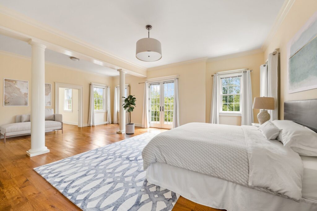 Bedroom view of trees small sitting area french doors to private terrac e