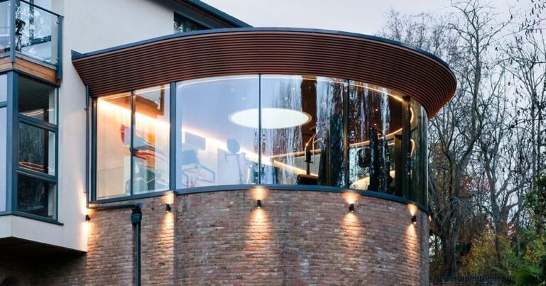 vita architecture’s curved glass gym fit-out expands family residence in the uk