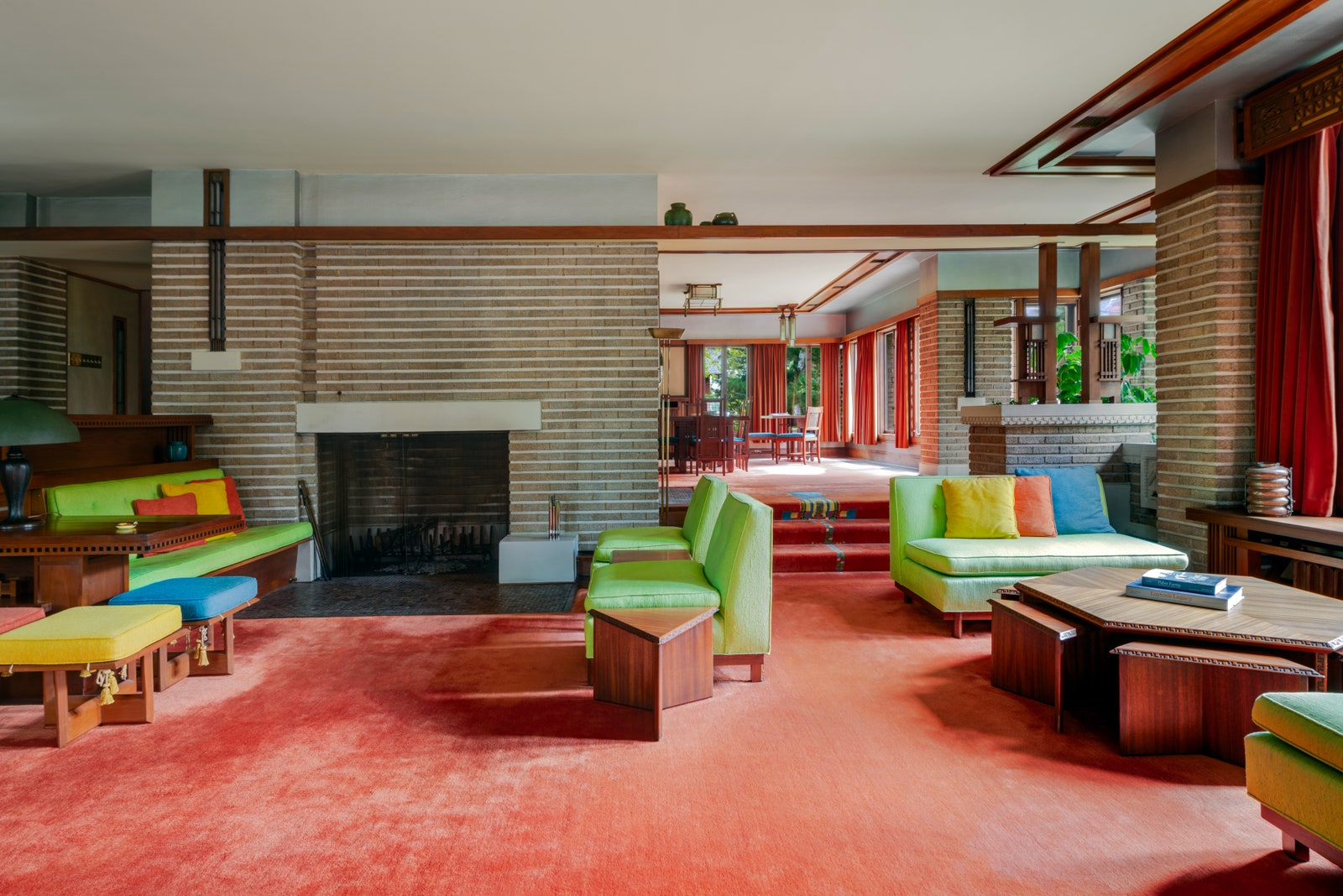 Living room of the Bogk House a home designed by Frank lloyd wright. Red carpets and midcentury furniture in primary...
