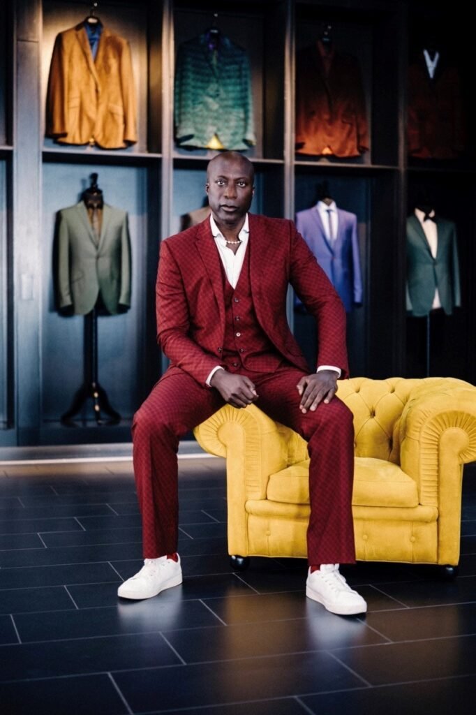 Ozwald Boateng perches on the Chester armchair upholstered in the collection's embossed leather.
