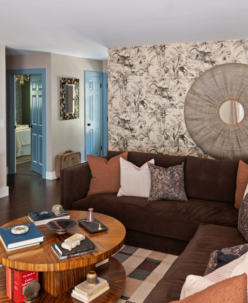 A Salvator wallpaper by Manuel Canovas and a Koa mirror by Jamie Young highlight the wall behind the sofa.