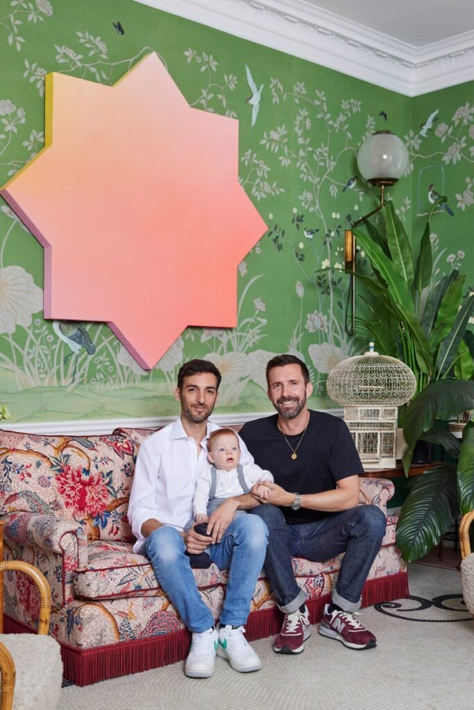 The family of three pictured on the sofa in their breakfast room