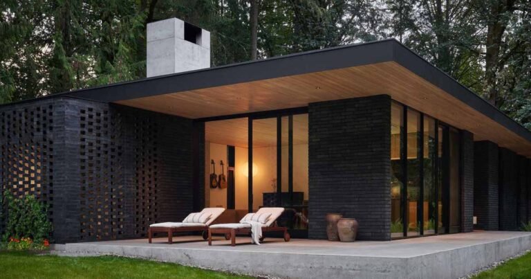A Black Brick Exterior Is Consistent With The Dark Forest Surrounding This Modern Home