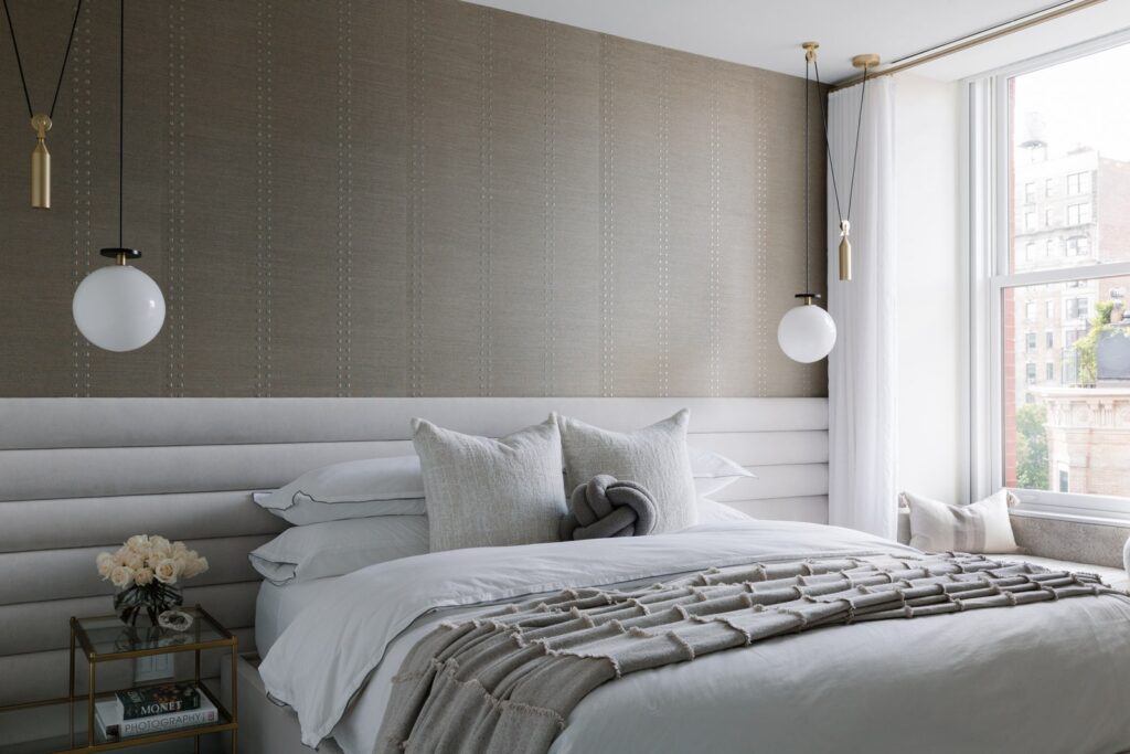 Grey bedroom with bed hanging lights and window