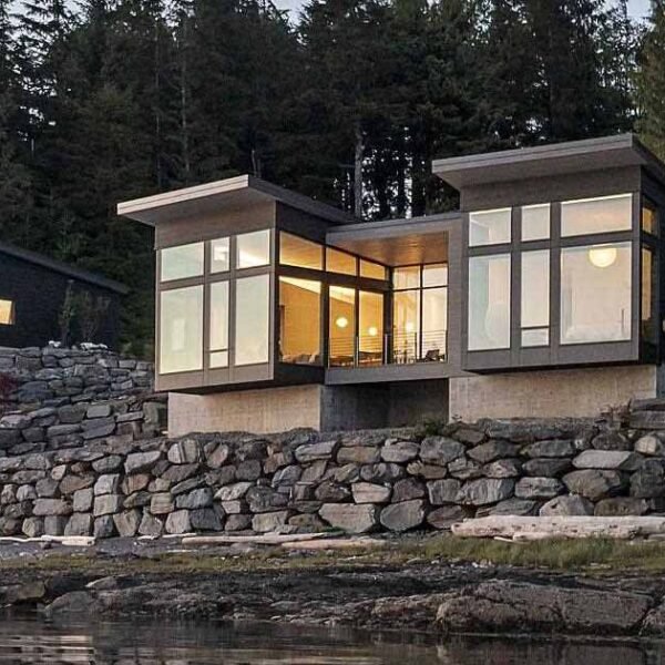 A New Home Overhanging The Water's Edge In Alaska