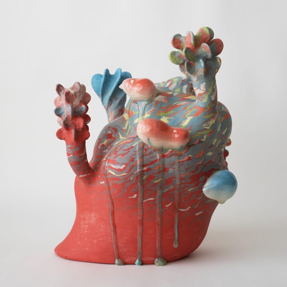 an abstract, colorful ceramic sculpture with nature-inspired elements evocative of coral or flowers