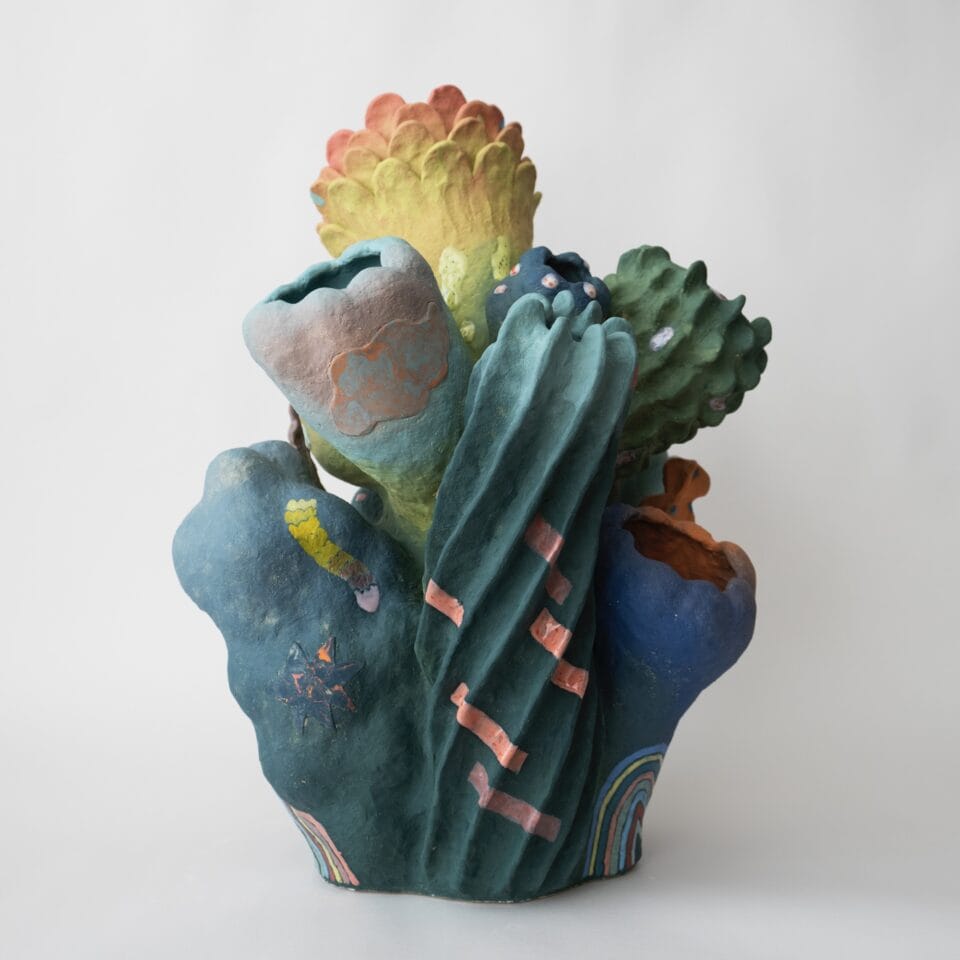 an abstract, colorful ceramic sculpture with nature-inspired elements evocative of coral or flowers