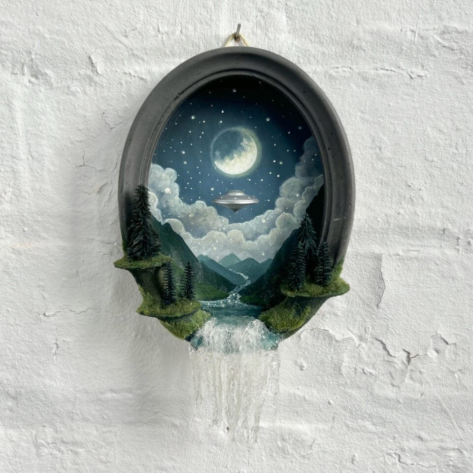 within a miniature ovoid frame, a detailed diorama depicts a landscape with a hovering UFO. a waterfall cascades over the bottom of the frame.