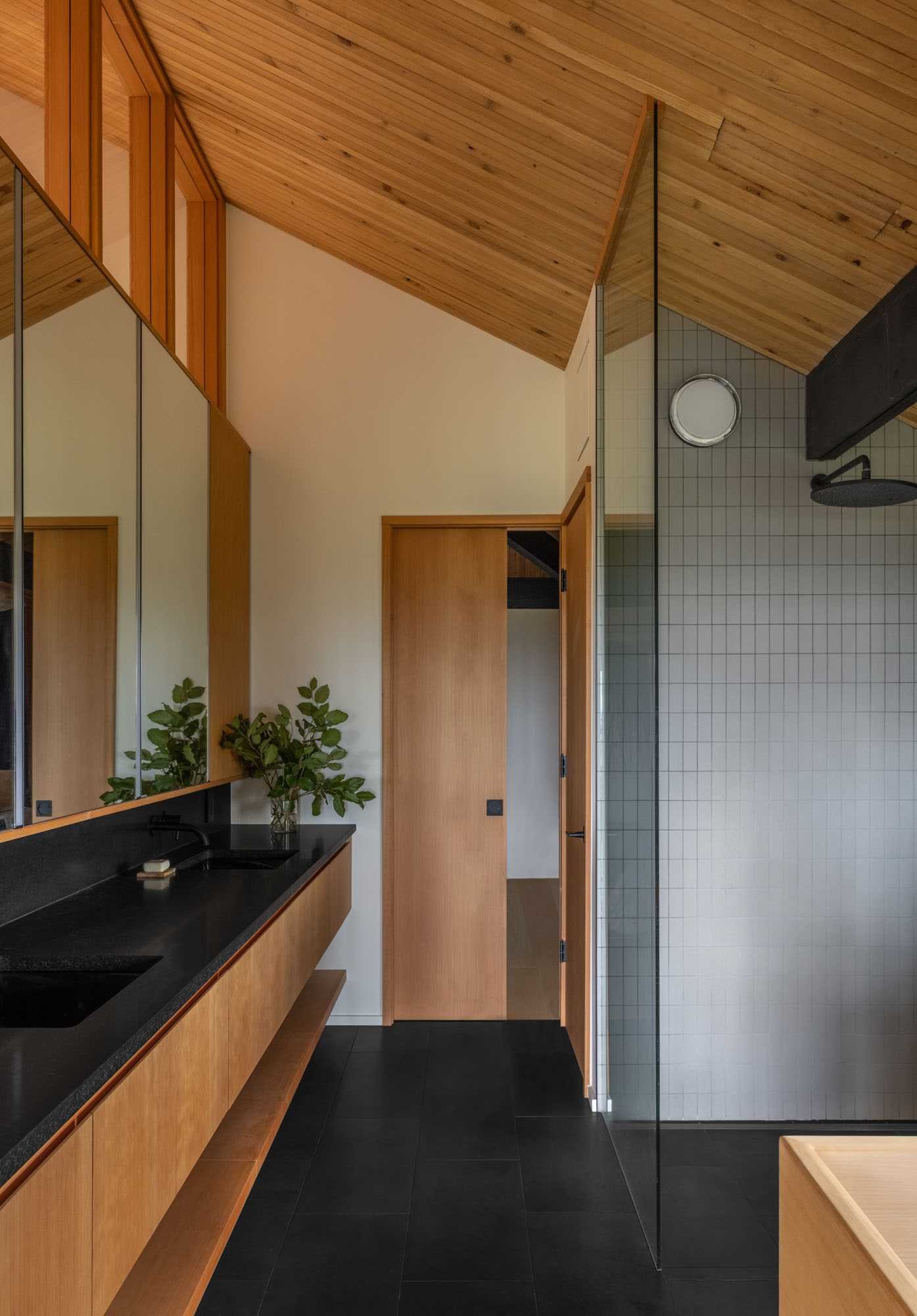 This primary bathroom has natural stone 