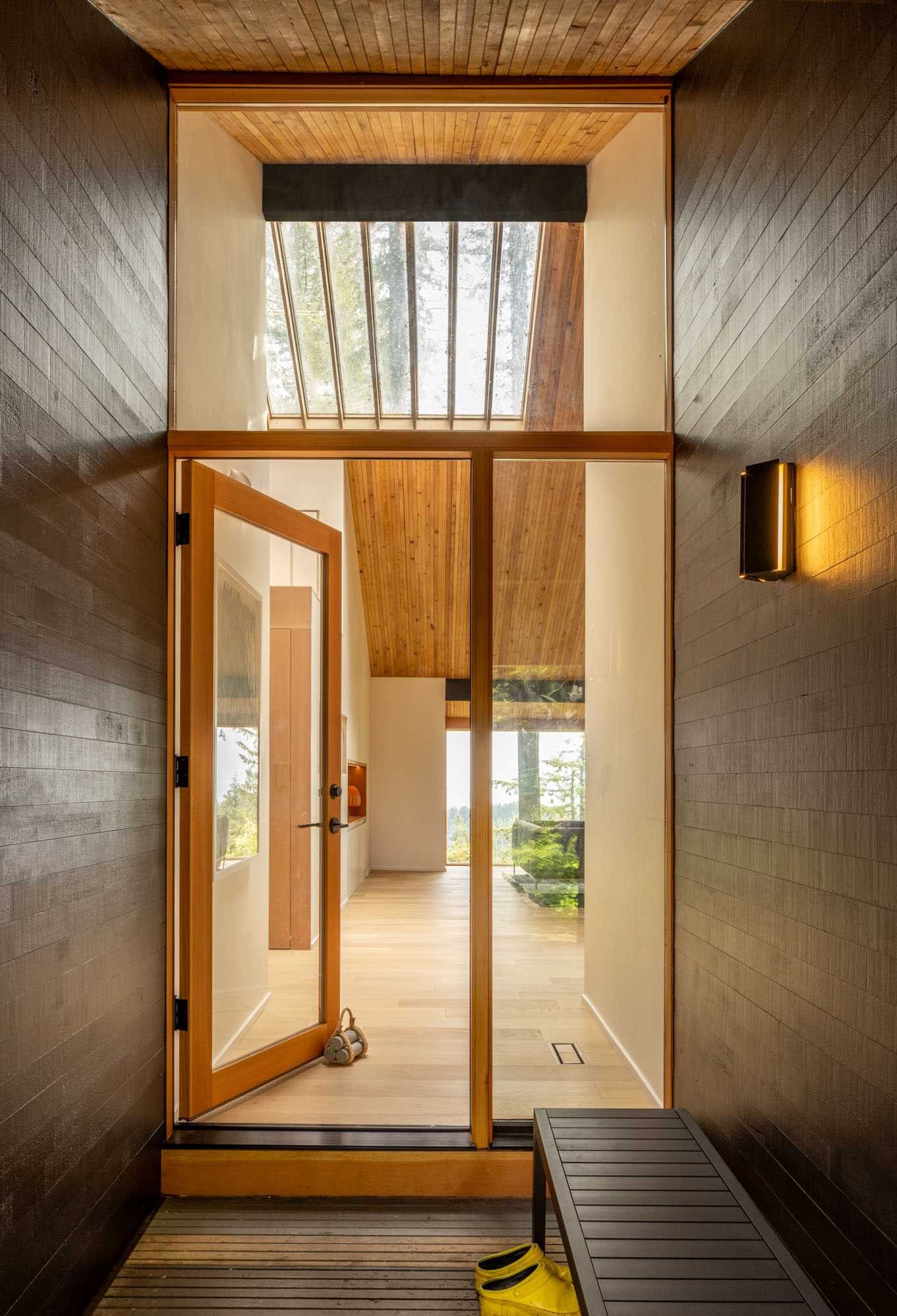 The front door and entryway are illuminated with natural light from the skylights.