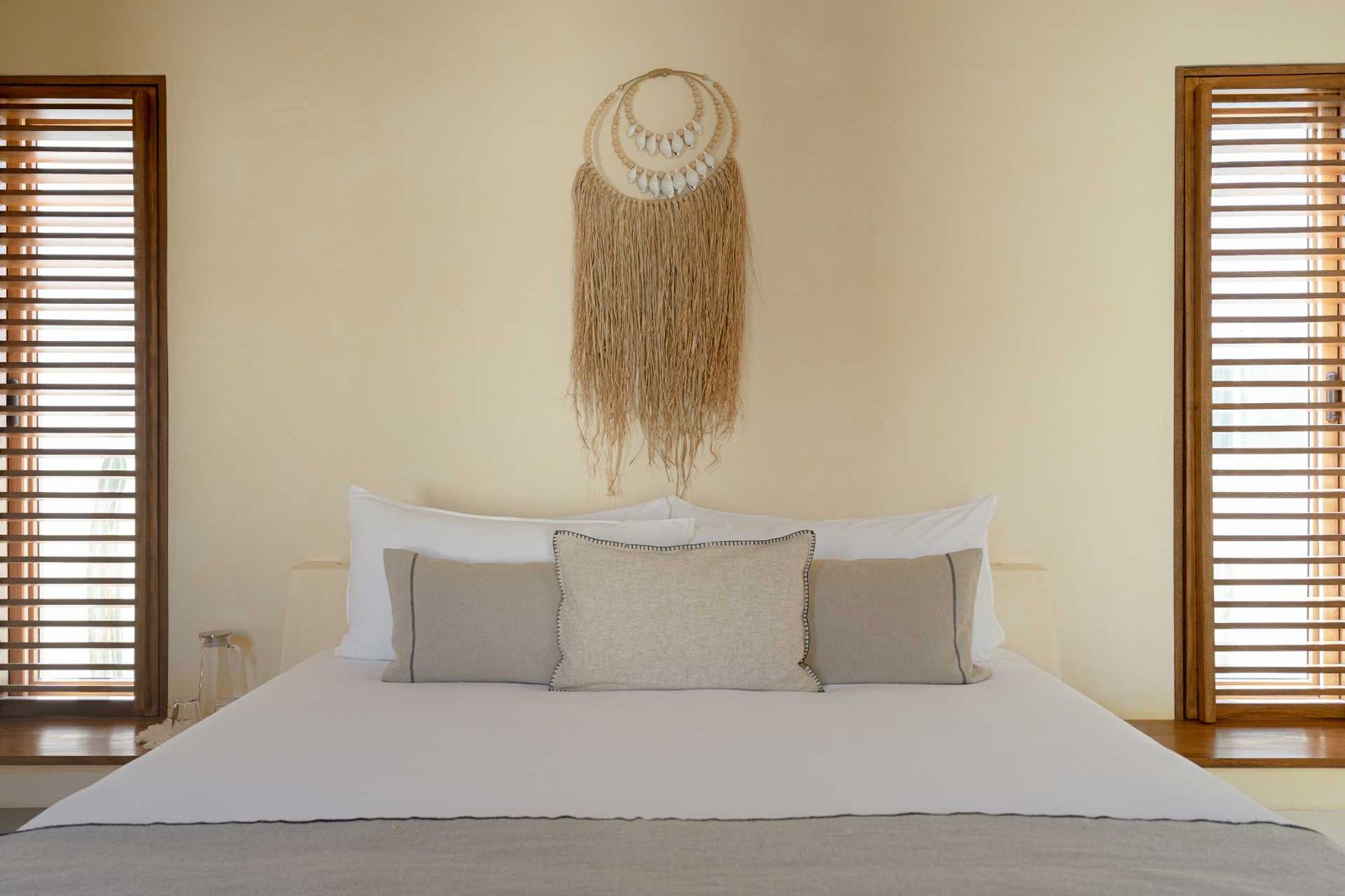 A contemporary beachside bedroom with a neutral palette.