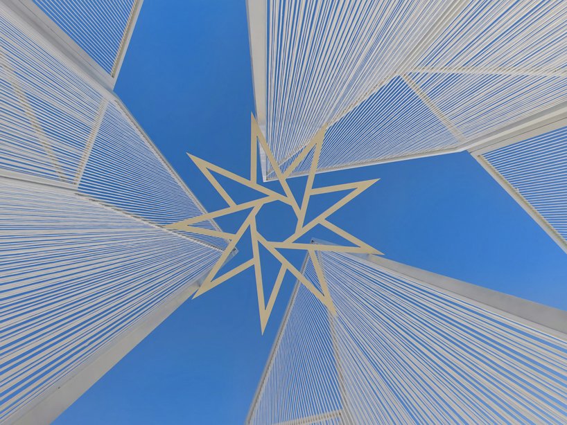 white flame installation's sharp geometry resembles ice crystals along lake in china