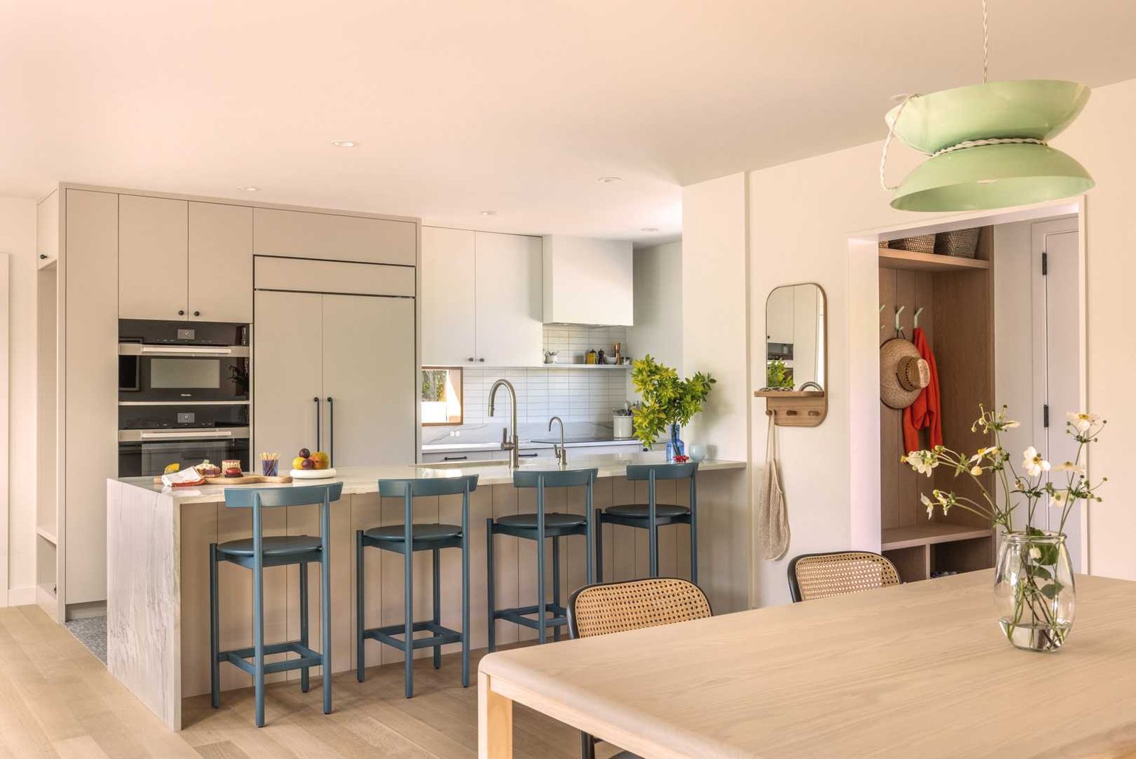 This new kitchen features a functional “U” shape with natural stone countertops, offering seamless access to the dining and living areas for a connected main floor experience.