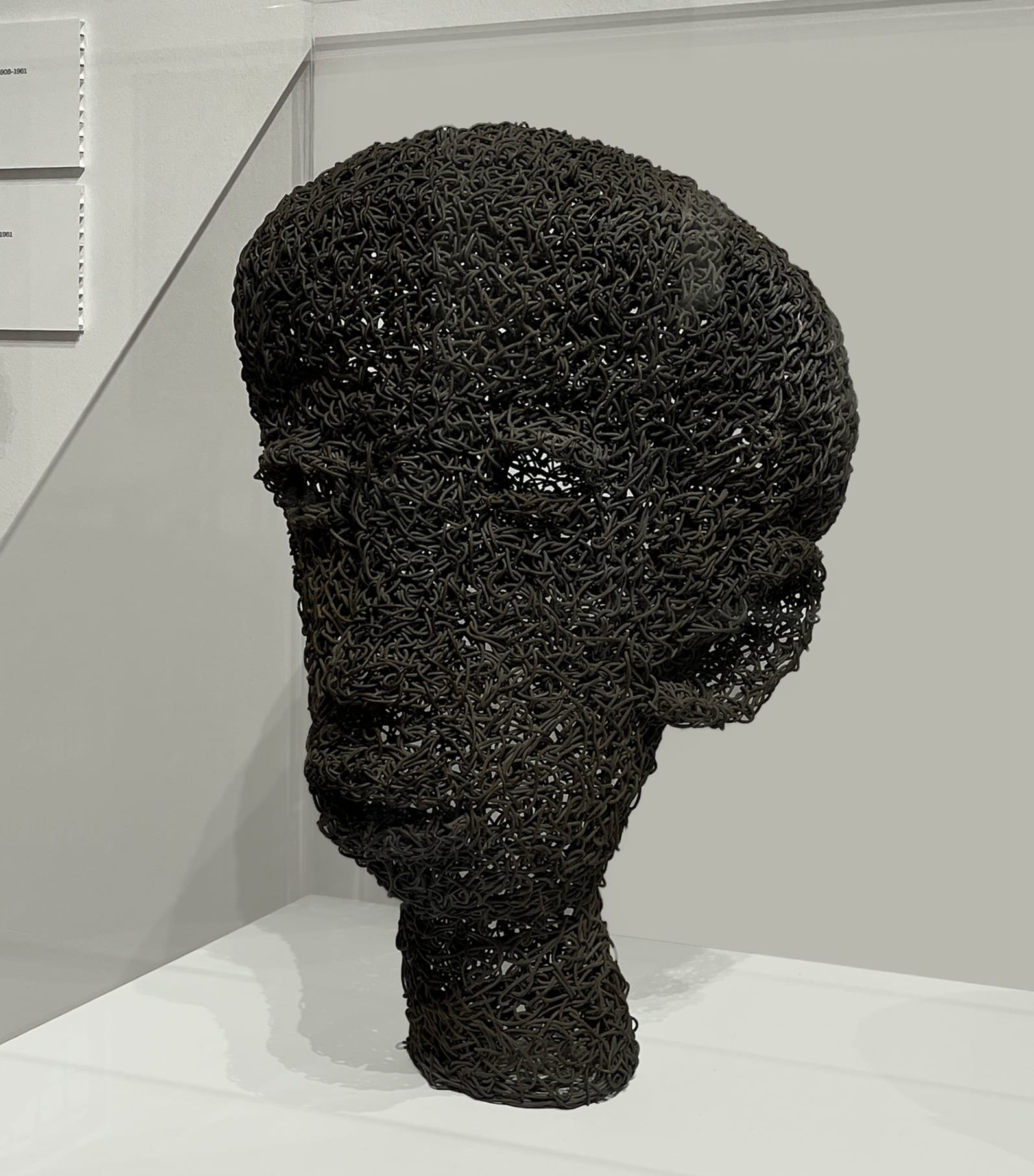 a sculptural bust made of black wire