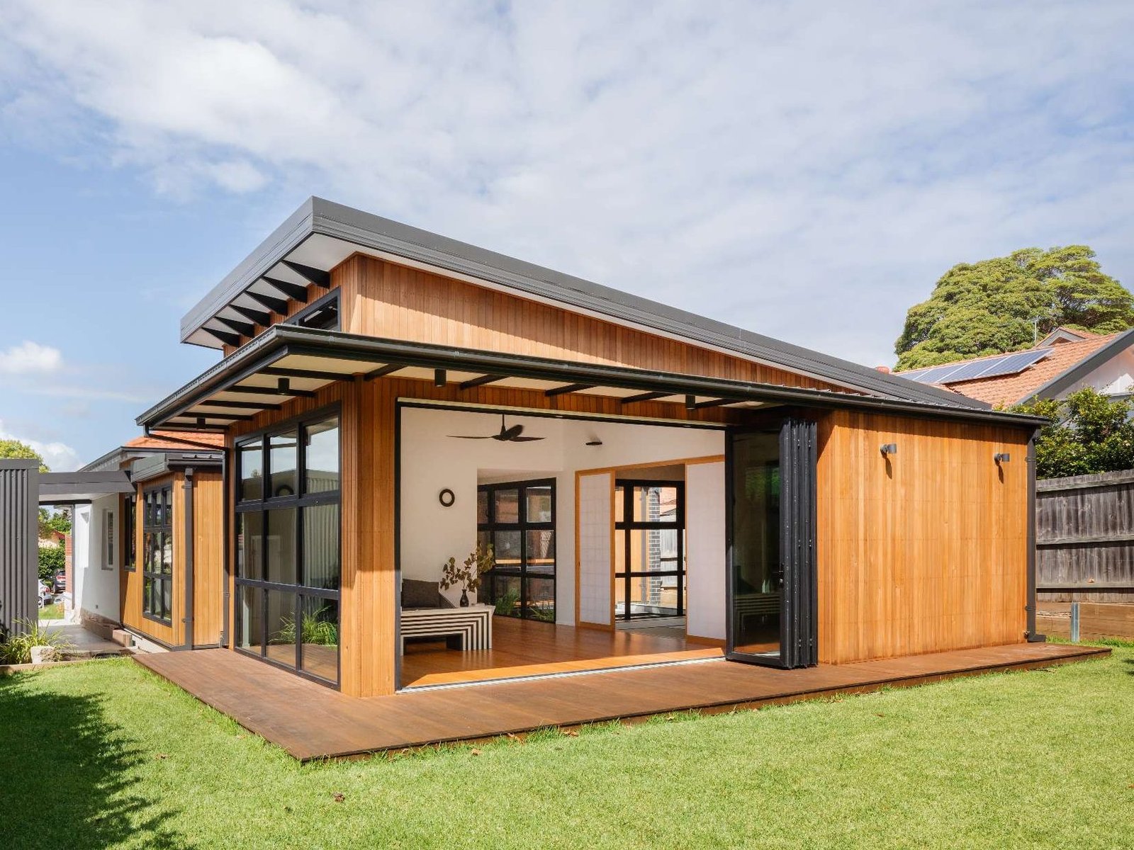 A low-lying timber extension opens directly to the garden, blending indoor comfort with outdoor ease in this Japanese-inspired Australian home.