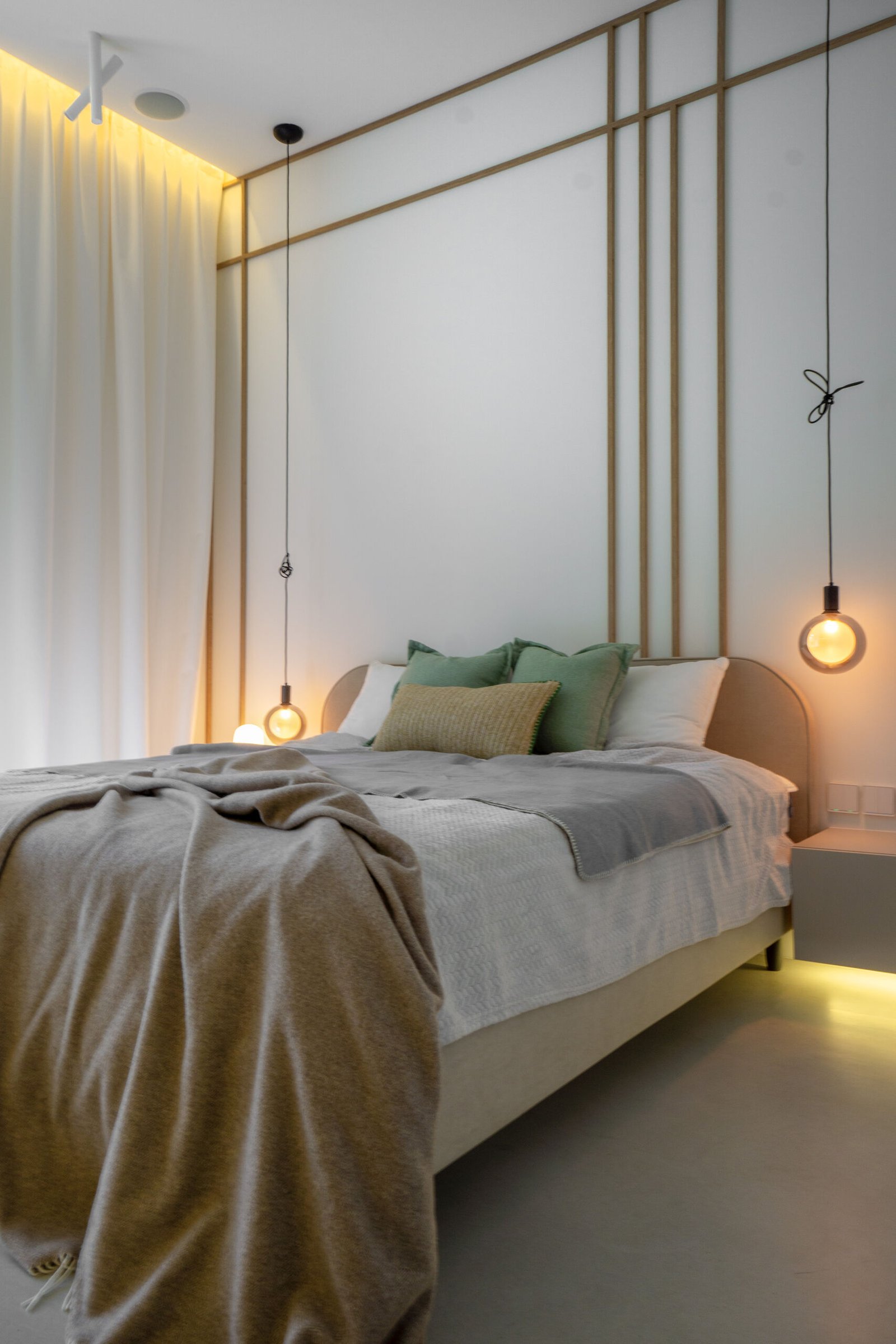 A modern bedroom with a wood strip accent.