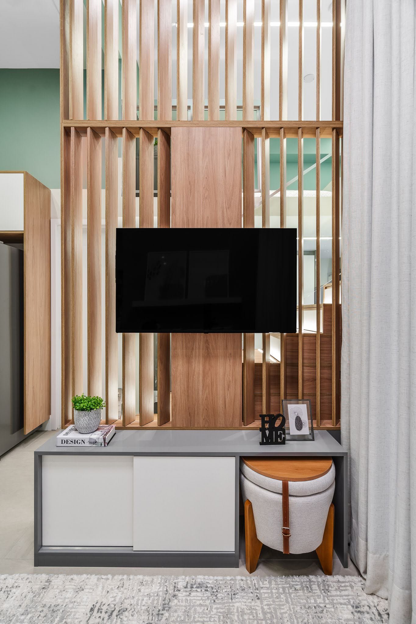 This divider between the stairs and living room, has moveable wood fins, allowing the light to be closed off when needed.