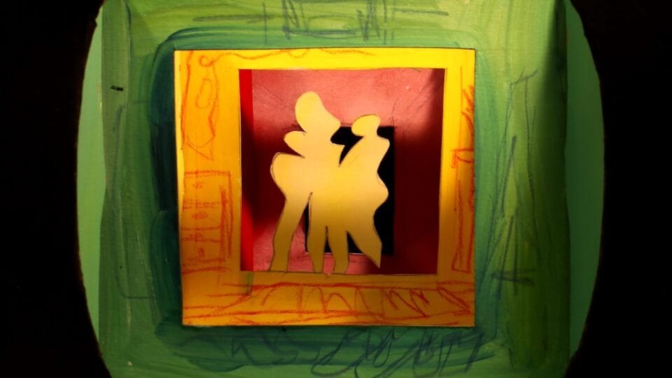 a layered assemblage of paper cut shapes, resembling two figures standing in a hallway