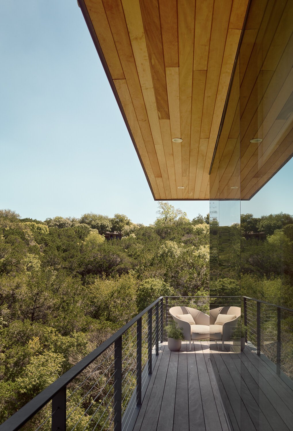 Off the main floor of this modern home, a balcony extends the living space outward without losing privacy. 