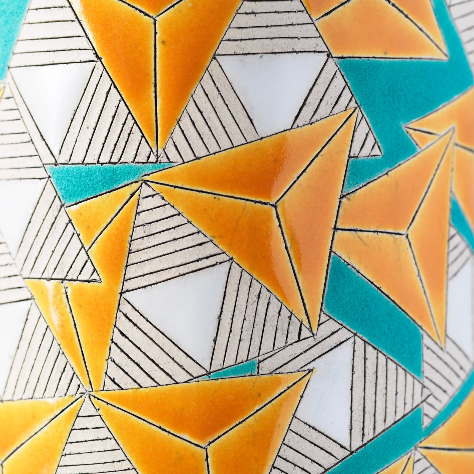 Detail of a geometric pattern in white, orange, and teal