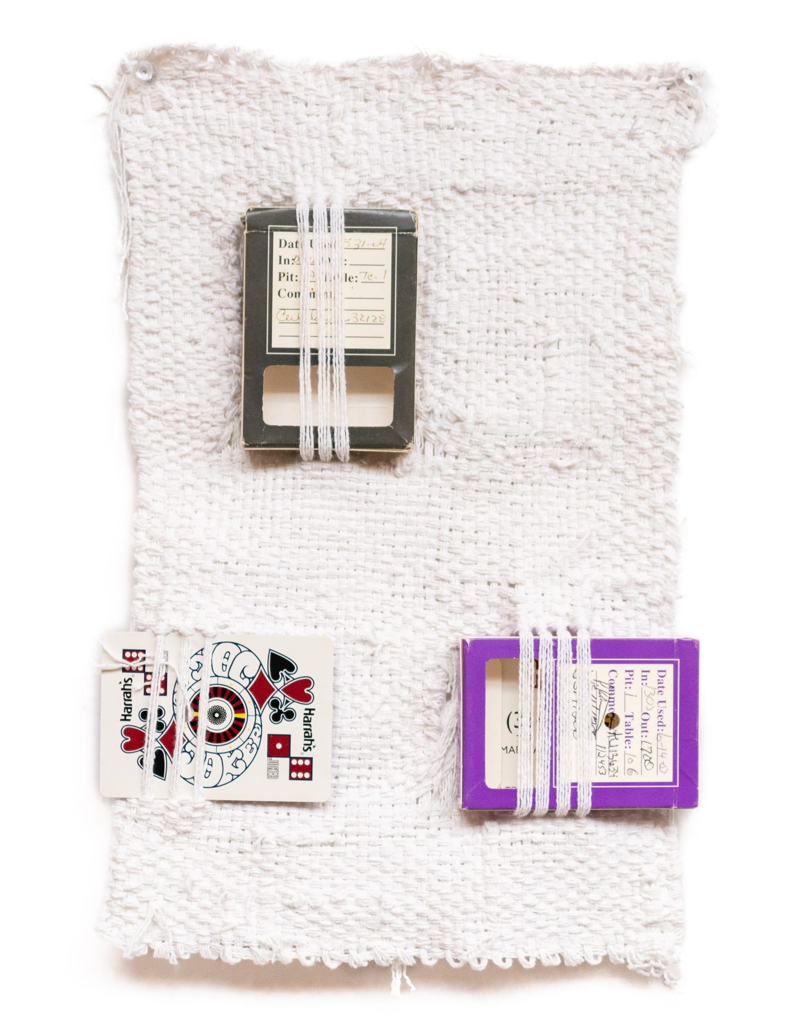 a weaving with two boxes and a playing card
