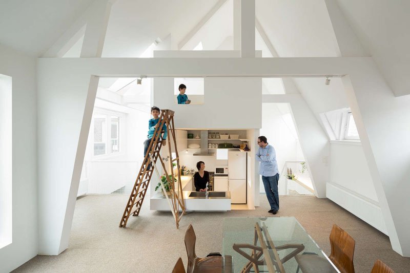 A sunken kitchen tucked into the central tower adds depth and separation without walls, maximizing both space and light in this compact family home.