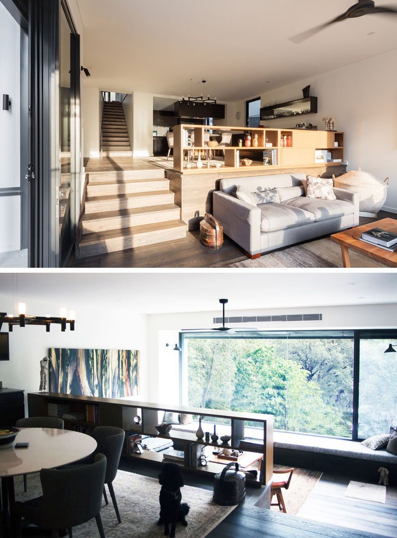 A small bookshelf doubles as a safety barrier above the living room, while the kitchen itself wraps around a corner, opening up sightlines toward the bush.
