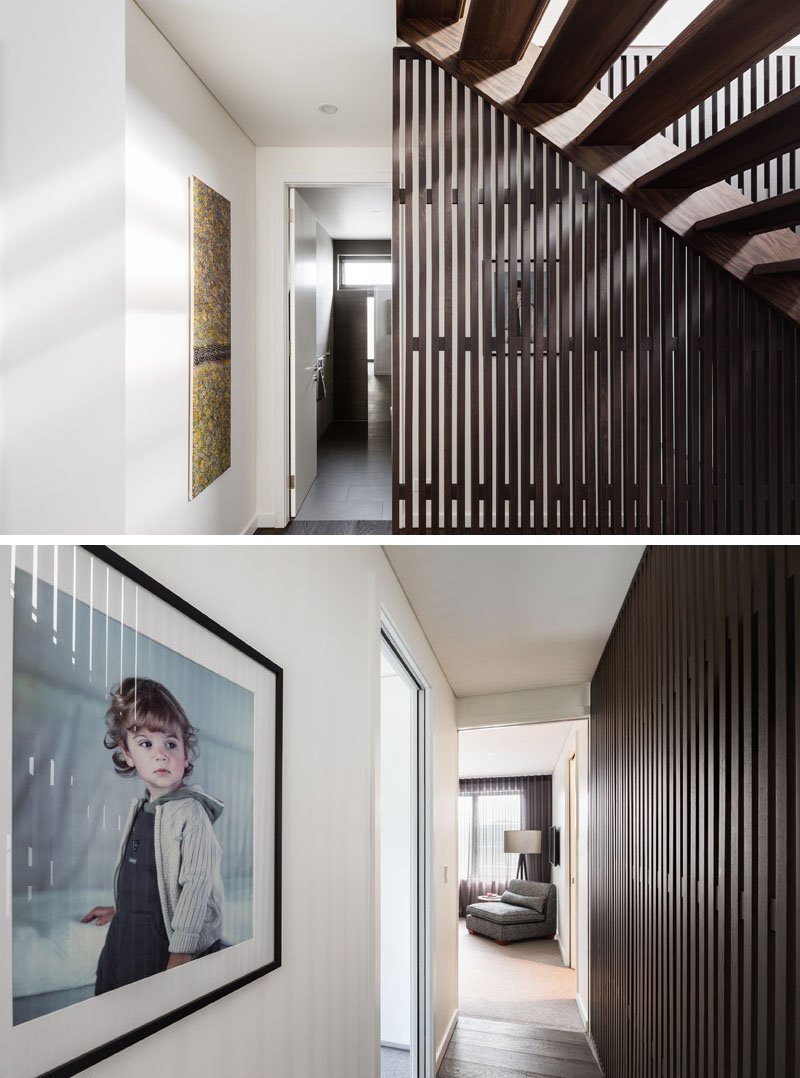 A hallway that links to the stairs and one of the bedrooms. Throughout the circulation spaces, large windows ensure that natural light reaches deep inside the home.