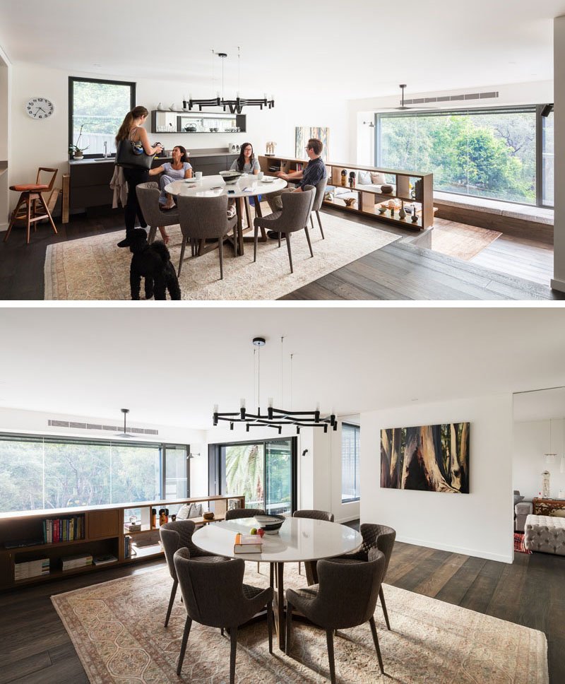 A small bookshelf doubles as a safety barrier above the living room, while the kitchen itself wraps around a corner, opening up sightlines toward the bush.