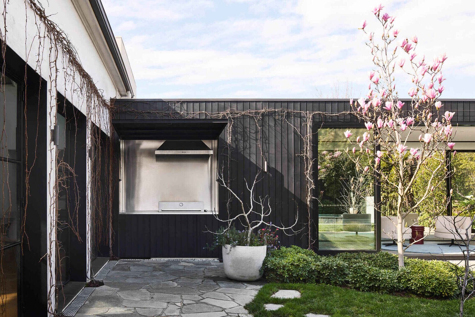 A patio and concealed BBQ blur the line between architecture and garden in this modern Australian home.