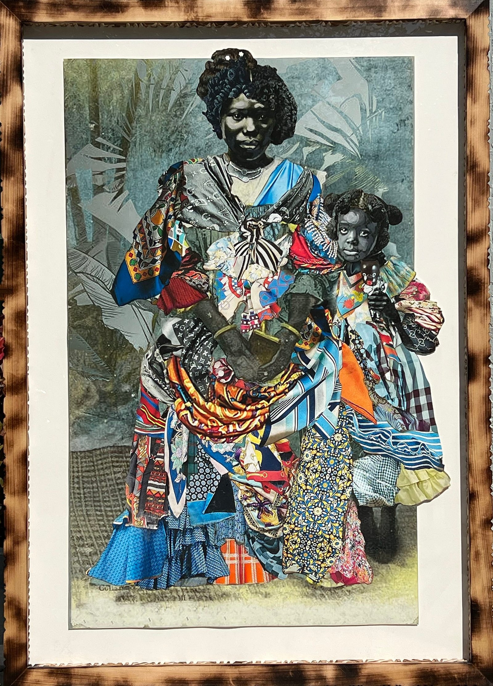 a framed portrait by Stan Squirewell, from an old photograph, of a Black woman and a young girl, with colorful, patterned fabrics collaged onto the image