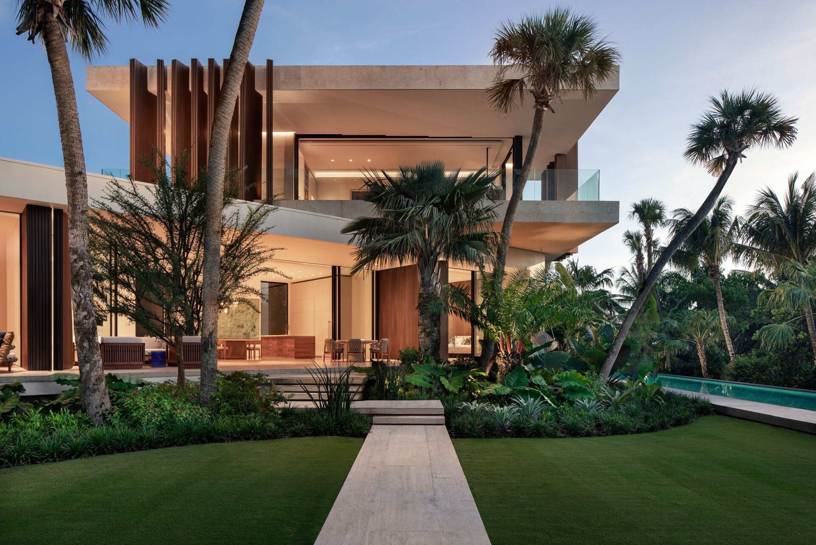 A tropical home with outdoor rooms and an infinity pool that blends naturally with the canal and surrounding greenery.
