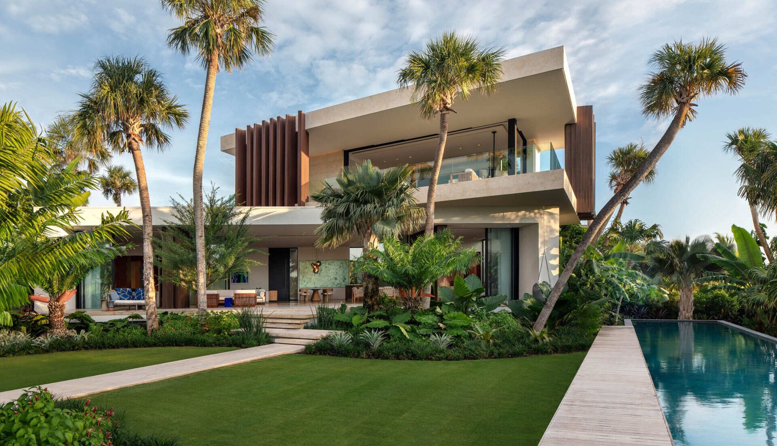 A tropical home with outdoor rooms and an infinity pool that blends naturally with the canal and surrounding greenery.
