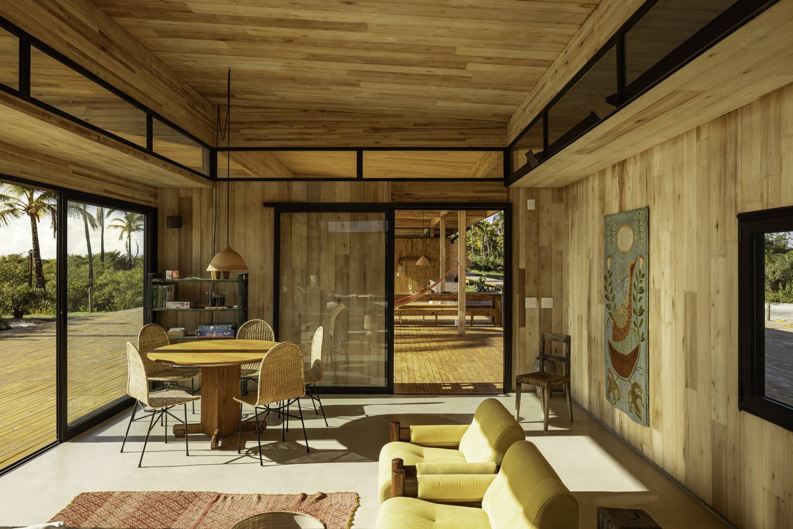 A modular home set between the river and the sea, designed for calm tropical living. Warm wood interiors, large glass openings, and open patios create a seamless flow between forest, coast, and indoor comfort.
