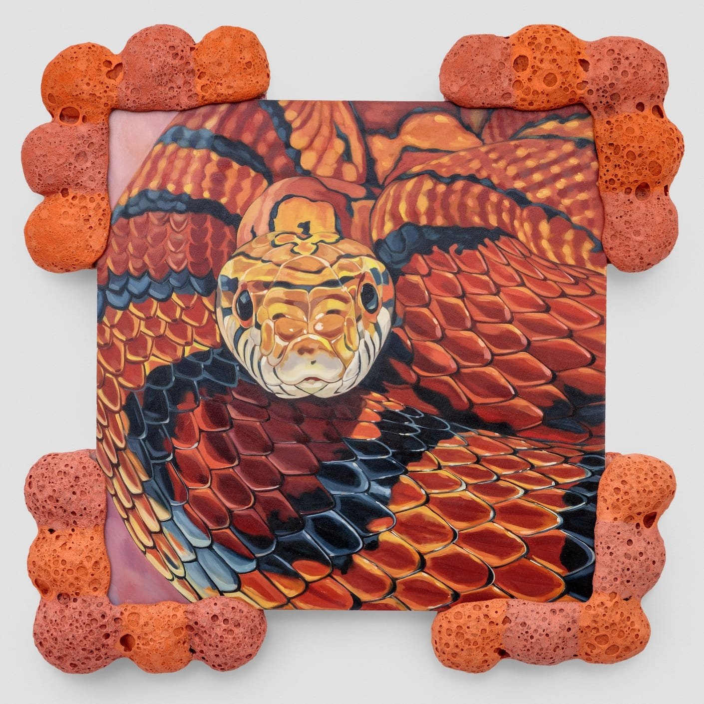 a ceramic sculpture by Stephanie Temma Heir with a painting of a snake at its center and orange bulbous edges 