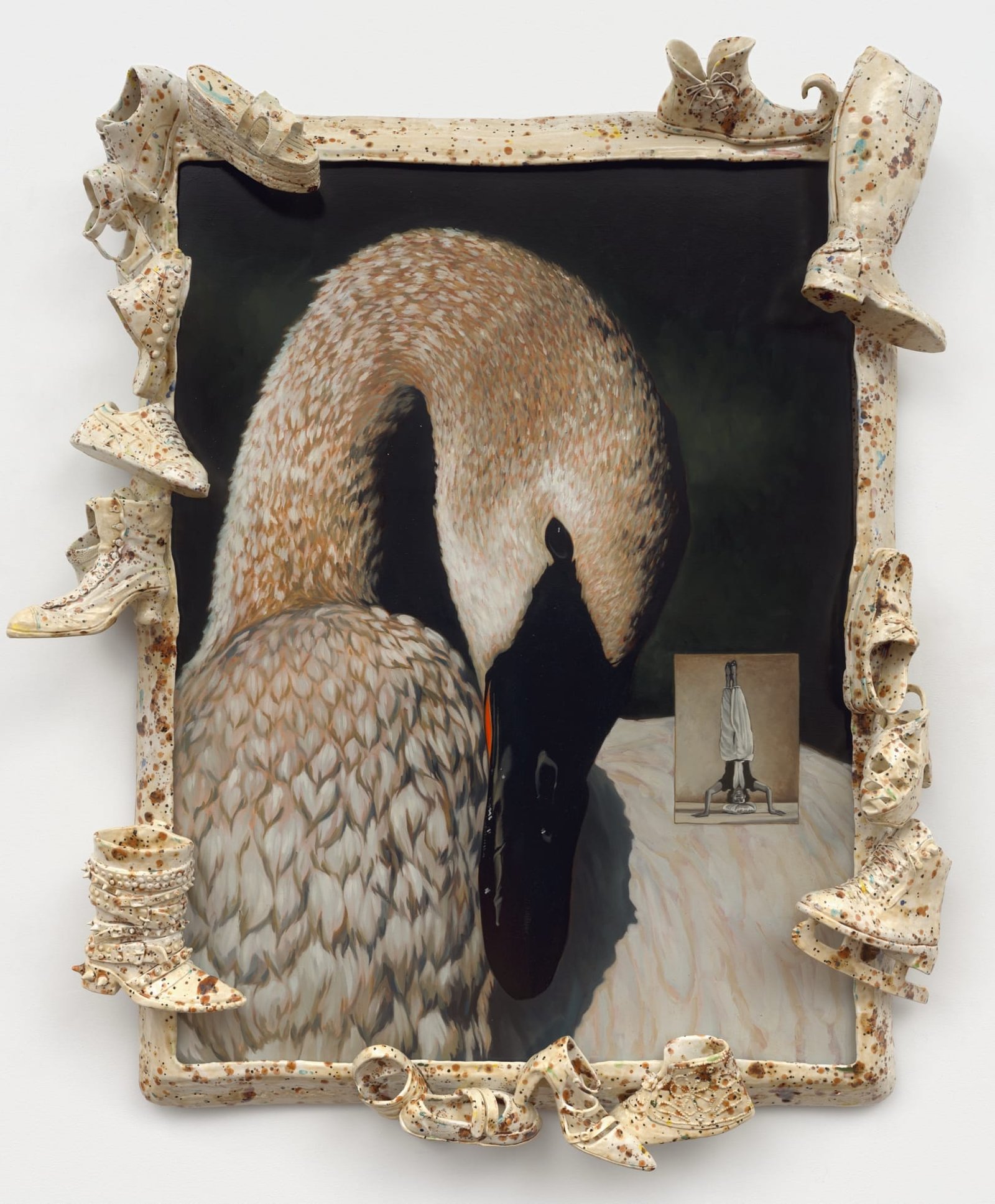a ceramic sculpture by Stephanie Temma Heir featuring a painting of a swan embedded with a smaller painting of a figure doing a handstand. the frame features speckled footwear