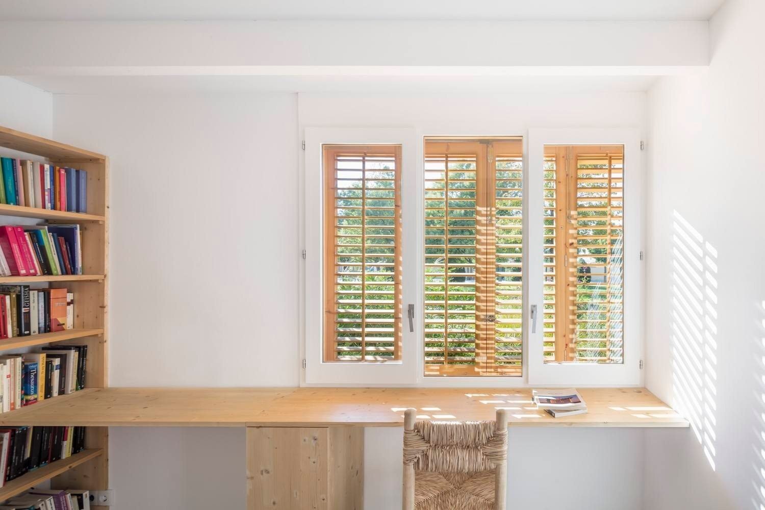 The home office highlights wood shutters and subtle textures, balancing focus, privacy, and natural light.