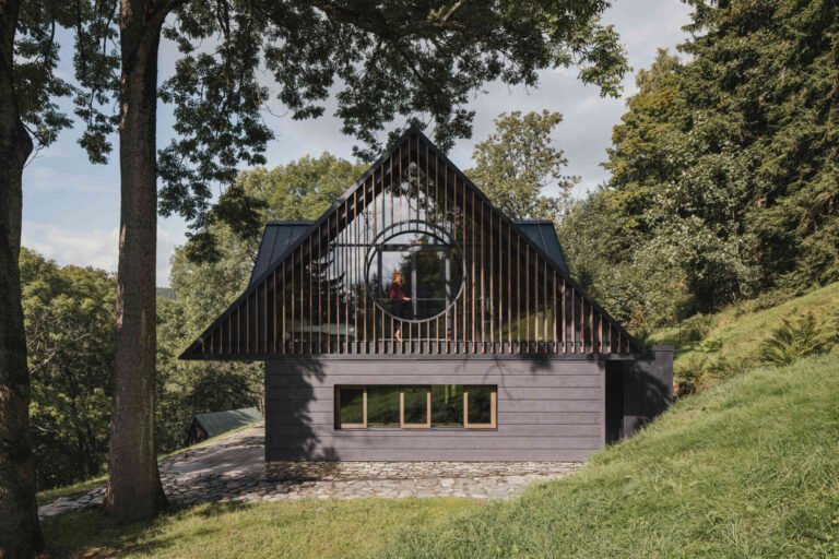 Traditional mountain cottage with steep roofs, stone bases, and timber gables blending authentic design with modern simplicity.